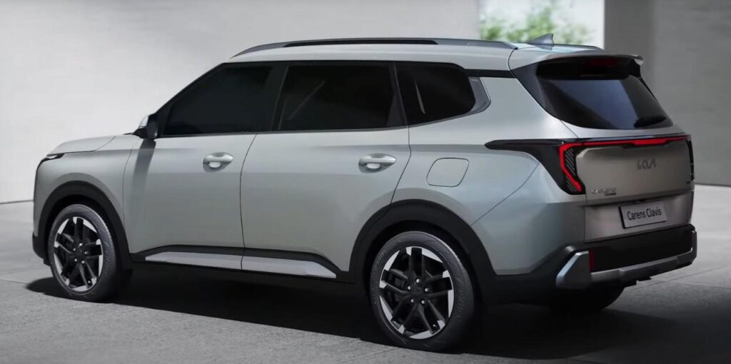 Rear side view of Kia Carens Clavis EV 2025 electric SUV in silver finish with modern tail light design