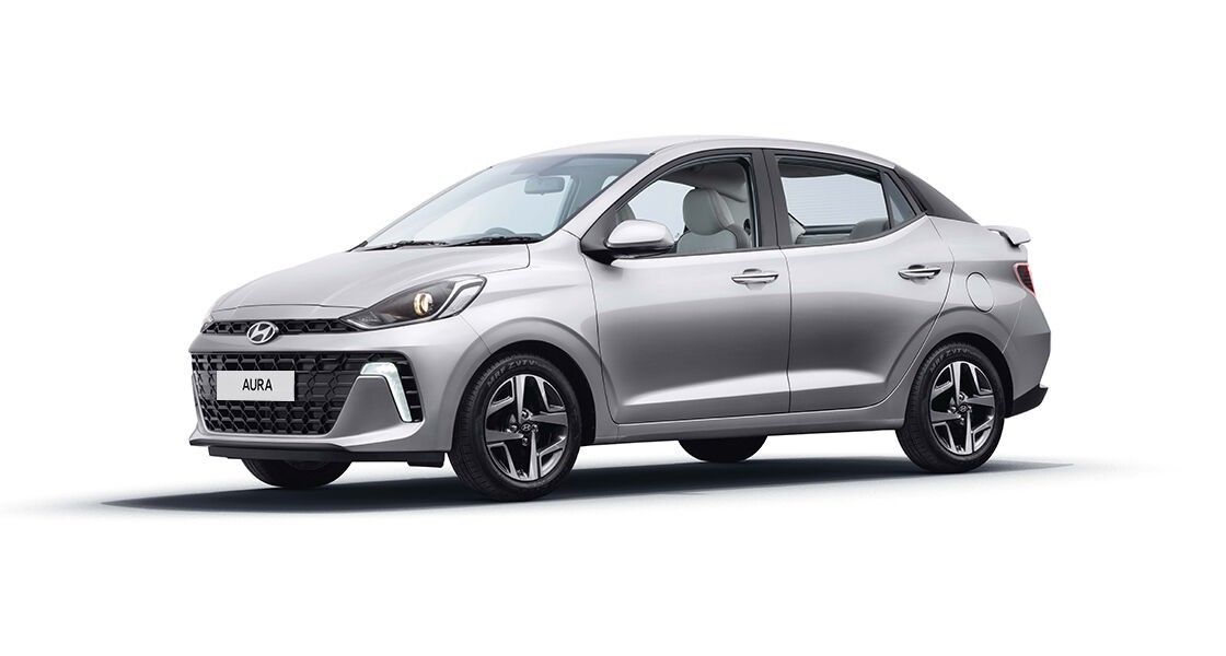 Hyundai AURA 2025 front side view in silver color with sporty design and alloy wheels