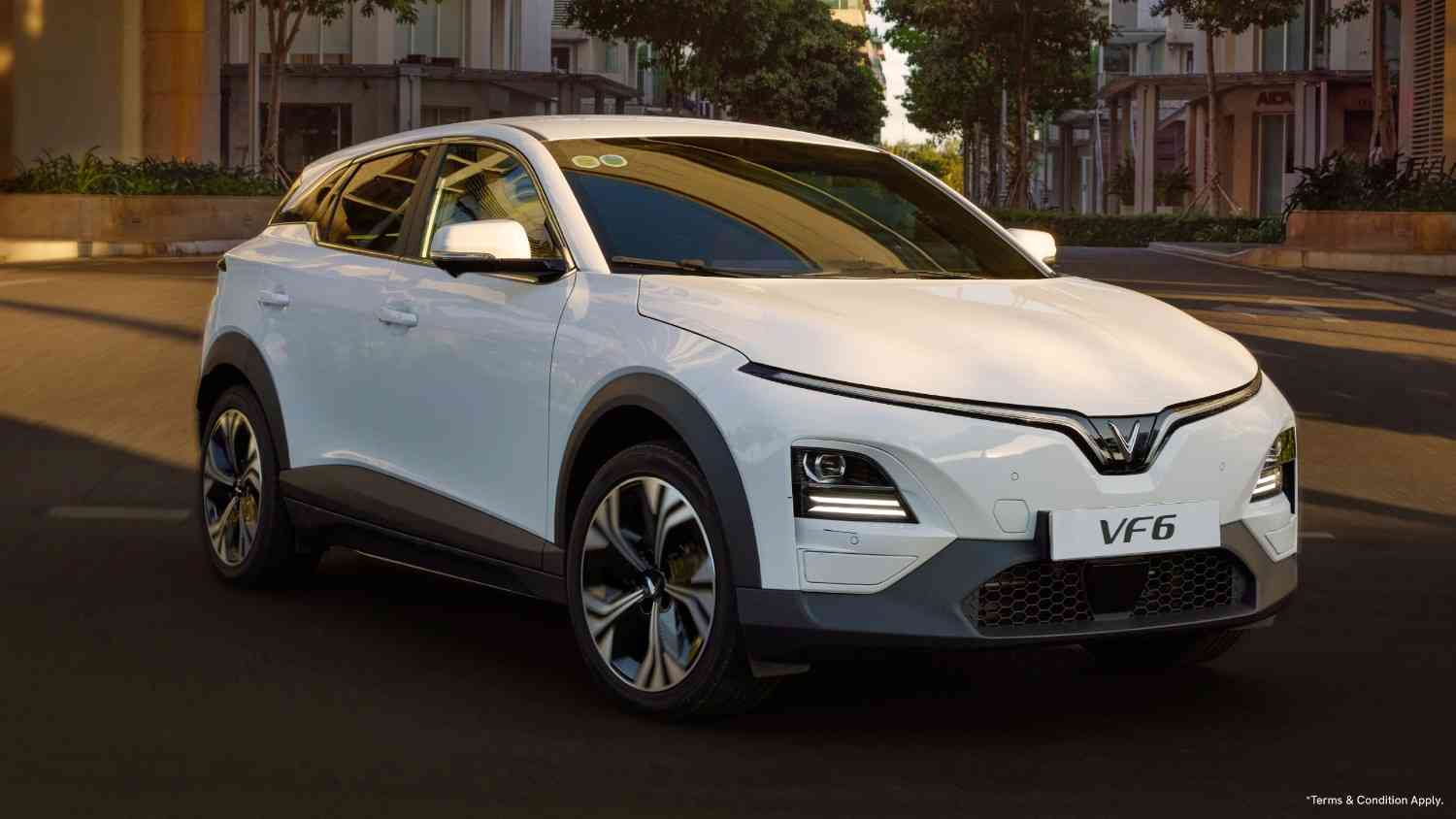 VinFast VF 6 electric SUV parked on a city road with sleek LED lights, modern aerodynamic body and bold front styling