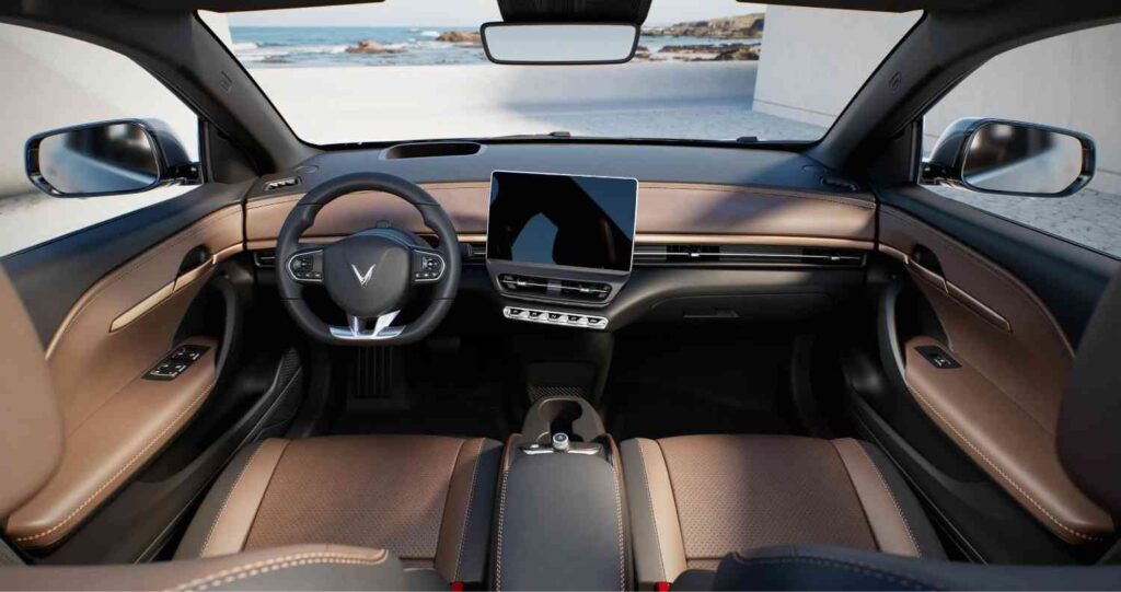 Interior view of VinFast VF 6 electric SUV featuring premium dual-tone leather seats, large touchscreen infotainment system, and modern dashboard design

